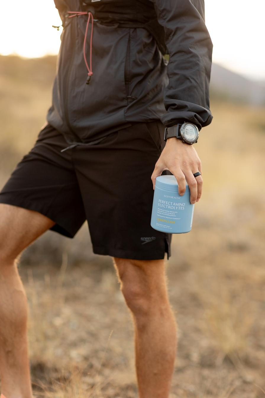 Dr. Nate holding a drink during a trail run